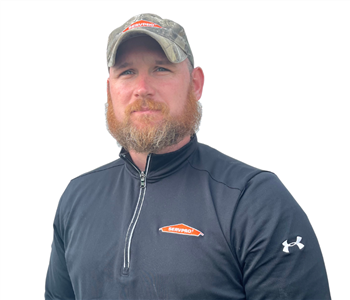 Man with beard in black SERVPRO shirt against white backdrop